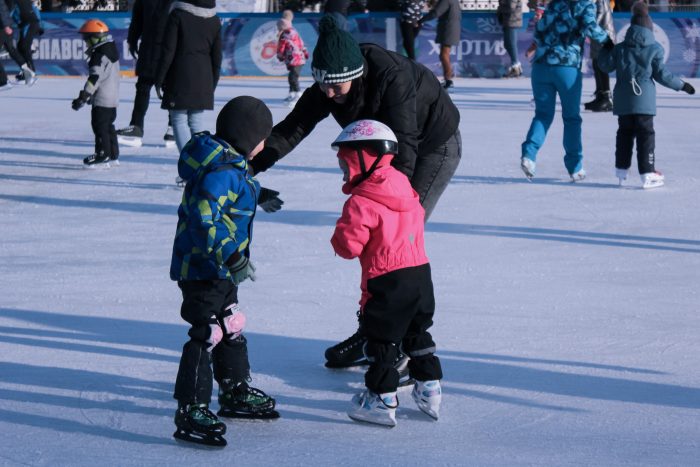 A group of parents and children ice skating
