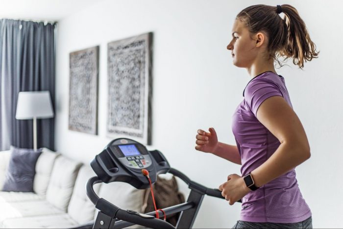 Woman running on a treadmill in pink top