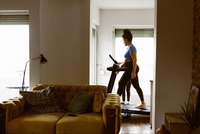 Woman walking on a treadmill on an incline