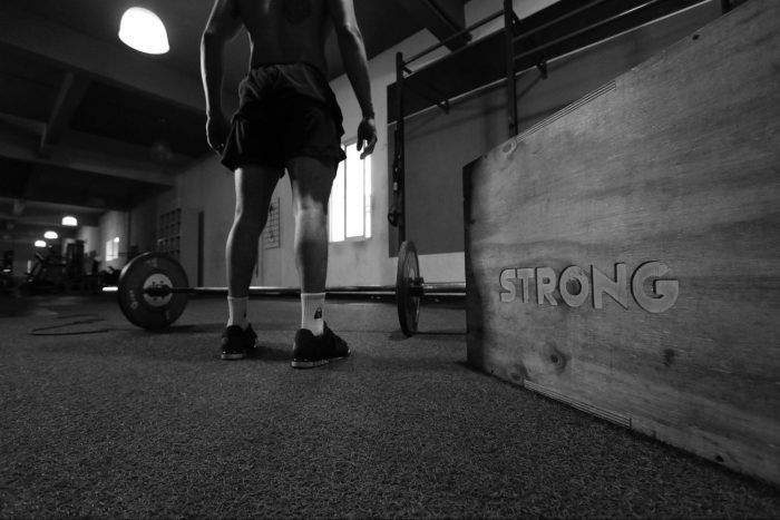 Man stood in front of barbell