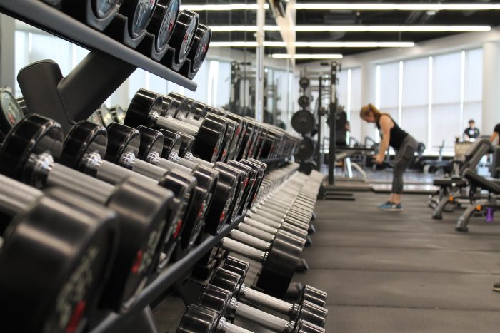 Woman lifting weights in the gym