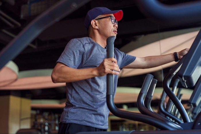Man on cross trainer