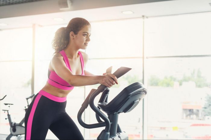 Woman on cross trainer 