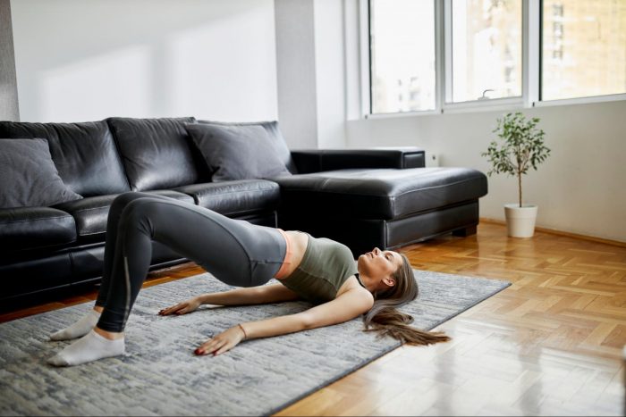 Woman performing glute bridge at home