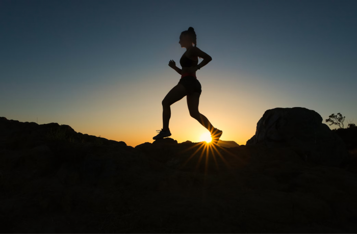 Woman running on a hill
