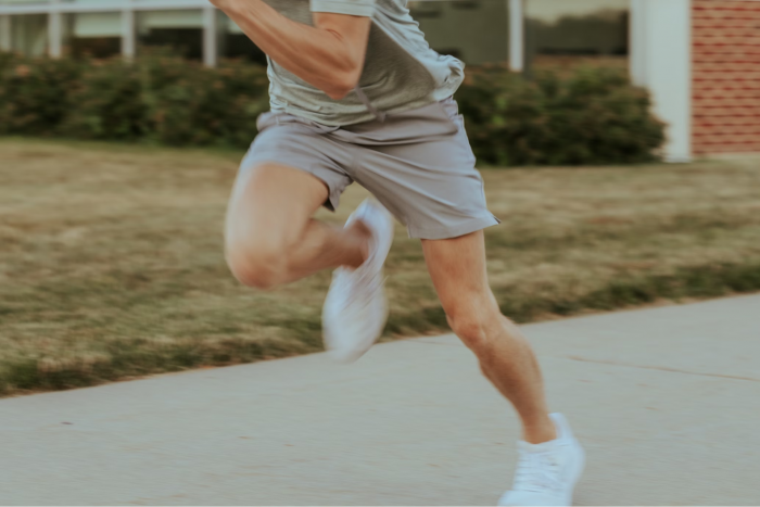 Man running in grey shorts fast
