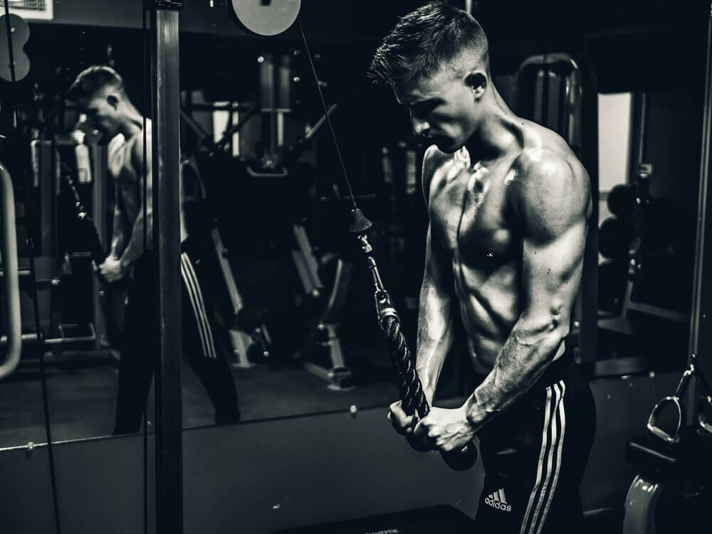 Man working out win the machine area