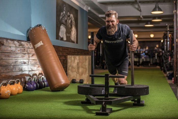 Man pushing sled