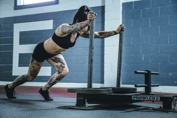 Woman pushing sled
