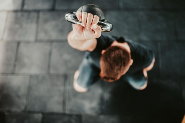 Man holding a kettlebell above his head