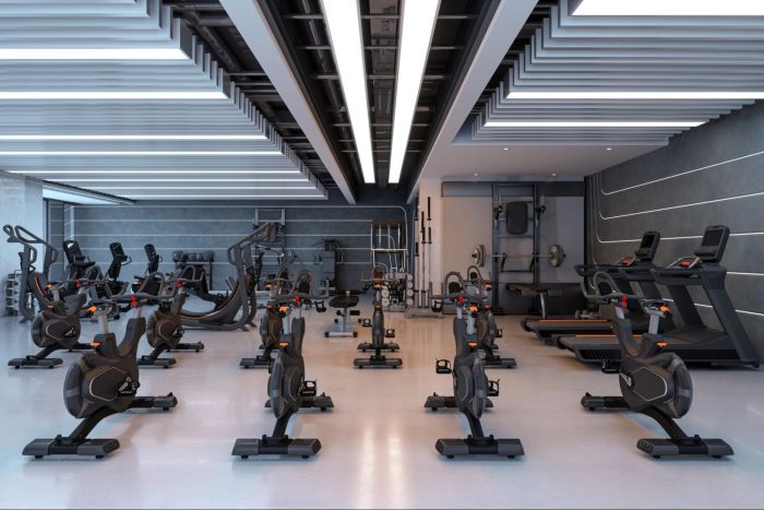 Empty gym studio with cycles, treadmills and stairmaster