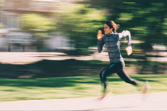 Woman running outdoors fast