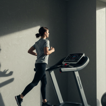 Woman running on a treadmill in a home gym