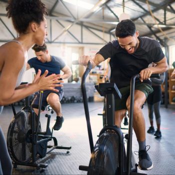 Air Bike fitness class with a group of people in a gym