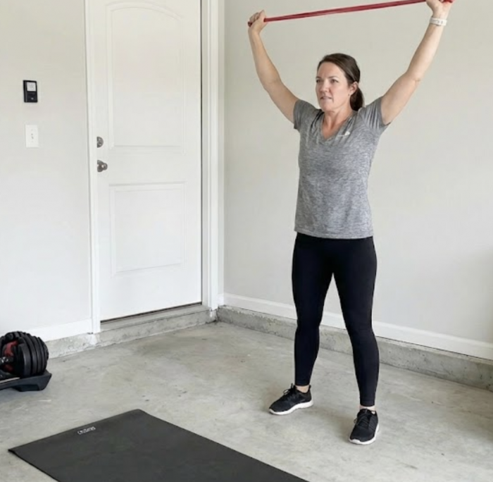 Woman using a resistance band at home