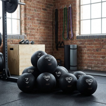 Group of slam balls stacked in a home gym