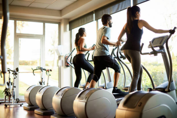 Group of people on a cross trainer