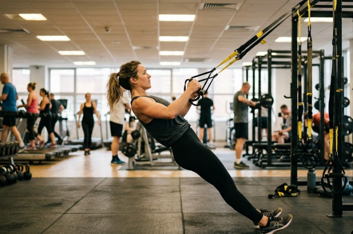 Woman using TRX cables in the gym