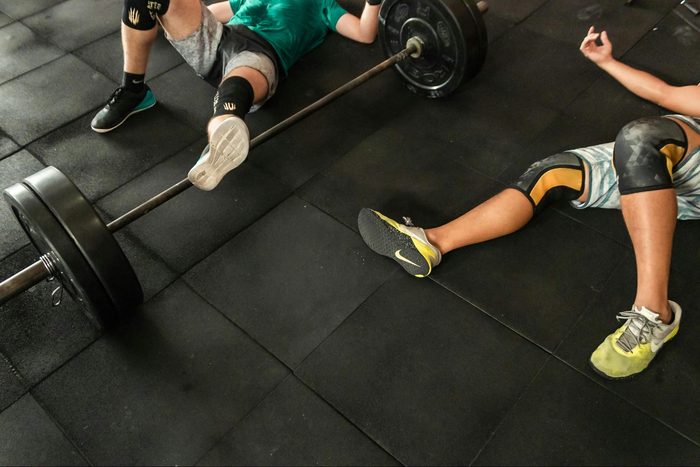 Two people exercising and laying on the floor after a workout