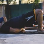 Man doing a glute bridge on a yoga mat