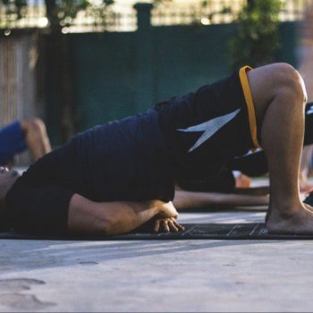 Man doing a glute bridge on a yoga mat